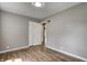 Bright bedroom featuring wood floors, neutral walls, and double-door closet at 6514 Jackson St, Indianapolis, IN 46241