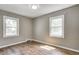 Bright bedroom with hardwood floors and two windows, offering a comfortable and inviting space at 6514 Jackson St, Indianapolis, IN 46241