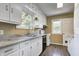 Bright kitchen with white cabinets, laminate counters, and modern appliances, creating a functional and inviting space at 6514 Jackson St, Indianapolis, IN 46241