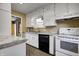 Functional kitchen featuring white cabinets, laminate counters, and essential appliances, ready for your culinary adventures at 6514 Jackson St, Indianapolis, IN 46241