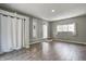 Comfortable room featuring hardwood floors, large windows, and a cozy atmosphere at 6514 Jackson St, Indianapolis, IN 46241