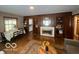 Living room features a decorative fireplace and hardwood floors, seamlessly blending comfort and classic design elements at 6514 Jackson St, Indianapolis, IN 46241