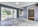 Bright sunroom features beautiful tile floors and a sliding glass door to the backyard at 6514 Jackson St, Indianapolis, IN 46241