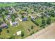 Aerial view of home, neighborhood and surrounding farmland with mature trees and lush lawns at 6702 W Willow Grove Dr, New Palestine, IN 46163