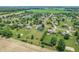 Aerial view of home, neighborhood and surrounding farmland with mature trees and lush lawns at 6702 W Willow Grove Dr, New Palestine, IN 46163