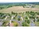 Aerial view of a neighborhood with farmland in the distance showcasing a home with a large yard at 6702 W Willow Grove Dr, New Palestine, IN 46163