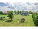 Sprawling backyard featuring a playground, mature trees, and a lush lawn, ideal for Gathering activities at 6702 W Willow Grove Dr, New Palestine, IN 46163