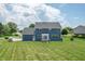 Spacious backyard with patio, lush lawn, and mature trees, providing a serene and private outdoor setting at 6702 W Willow Grove Dr, New Palestine, IN 46163