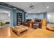 Spacious basement living area with wood-look floors, theater seating, and a minibar at 6702 W Willow Grove Dr, New Palestine, IN 46163
