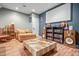 Finished basement with comfortable seating, movie screen, and storage shelves at 6702 W Willow Grove Dr, New Palestine, IN 46163