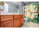 Bathroom with a wooden vanity, monkey themed shower curtain and a light gray painted walls at 6702 W Willow Grove Dr, New Palestine, IN 46163