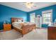 Bright bedroom with wood-frame bed, two windows, and a ceiling fan at 6702 W Willow Grove Dr, New Palestine, IN 46163