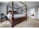 Bedroom boasting a canopy bed, carpet, and an attached bathroom at 6702 W Willow Grove Dr, New Palestine, IN 46163