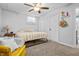 Well-lit bedroom featuring natural light, a ceiling fan, and carpeted floors at 6702 W Willow Grove Dr, New Palestine, IN 46163
