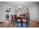 Charming dining room with stylish chandelier and access to the kitchen at 6702 W Willow Grove Dr, New Palestine, IN 46163