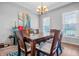 Bright dining room featuring a wooden table, four chairs, and a large painting at 6702 W Willow Grove Dr, New Palestine, IN 46163