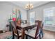 Bright dining room with a chandelier, table, and lots of natural light, perfect for Gathering meals and gatherings at 6702 W Willow Grove Dr, New Palestine, IN 46163