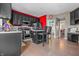 Modern kitchen featuring dark cabinetry, stainless steel appliances, and hardwood flooring at 6702 W Willow Grove Dr, New Palestine, IN 46163