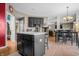 Spacious kitchen with a central island, bar stool seating, and an open layout connecting to the dining area at 6702 W Willow Grove Dr, New Palestine, IN 46163