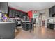 Stylish kitchen with dark cabinets, sleek appliances, breakfast bar, and hardwood flooring at 6702 W Willow Grove Dr, New Palestine, IN 46163