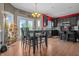 Cozy kitchen and dining area with hardwood floors, dark cabinets, and plenty of natural light at 6702 W Willow Grove Dr, New Palestine, IN 46163