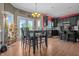 Bright kitchen featuring dark cabinetry, hardwood floors and access to the backyard at 6702 W Willow Grove Dr, New Palestine, IN 46163