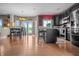 Bright kitchen featuring hardwood floors, modern appliances, and a breakfast bar area at 6702 W Willow Grove Dr, New Palestine, IN 46163