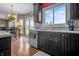 Bright kitchen featuring a window over the sink, modern appliances, and a view of the backyard at 6702 W Willow Grove Dr, New Palestine, IN 46163