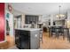 Open-concept kitchen featuring a central island, hardwood floors and seamless flow to the dining area at 6702 W Willow Grove Dr, New Palestine, IN 46163