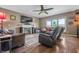 Cozy living room featuring a fireplace, hardwood floors, and comfortable furnishings at 6702 W Willow Grove Dr, New Palestine, IN 46163
