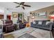 Comfortable living room with hardwood floors, sofa, and an adjacent stairway at 6702 W Willow Grove Dr, New Palestine, IN 46163
