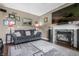 Inviting living room featuring a fireplace, comfortable sofa, and stylish decor, perfect for relaxation at 6702 W Willow Grove Dr, New Palestine, IN 46163