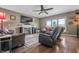 Comfortable living room with fireplace, seating, hardwood floors, and a view to the outside, perfect for relaxation at 6702 W Willow Grove Dr, New Palestine, IN 46163