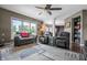 Bright living room with large windows, comfortable seating, hardwood floors and access to other parts of the home at 6702 W Willow Grove Dr, New Palestine, IN 46163