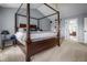 Bright main bedroom with carpet, gray walls, ceiling fan, and an ensuite bath just through the door at 6702 W Willow Grove Dr, New Palestine, IN 46163