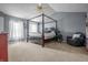 Spacious carpeted main bedroom featuring a four poster bed, vaulted ceiling and a ceiling fan at 6702 W Willow Grove Dr, New Palestine, IN 46163