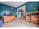 Spacious home office featuring hardwood floors, a wooden desk, and an adjacent stairway at 6702 W Willow Grove Dr, New Palestine, IN 46163