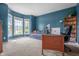 Spacious home office with large windows, desk, and built-in bookshelves for a productive and organized workspace at 6702 W Willow Grove Dr, New Palestine, IN 46163