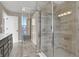 Well-lit bathroom featuring a glass-enclosed shower with tiled walls and flooring at 6770 W Buck Stone Dr, McCordsville, IN 46055