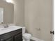 Well-lit half bath with modern fixtures, vanity, and toilet offers convenience for guests at 6770 W Buck Stone Dr, McCordsville, IN 46055