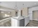 Well-appointed kitchen island featuring a stainless steel dishwasher and a view into the living space at 6770 W Buck Stone Dr, McCordsville, IN 46055