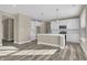 Modern kitchen boasts a central island, stainless appliances, and sleek white cabinets at 6770 W Buck Stone Dr, McCordsville, IN 46055