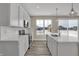 Modern kitchen with stainless steel appliances, white subway tile backsplash, and an island overlooking the backyard at 6770 W Buck Stone Dr, McCordsville, IN 46055