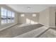 Light-filled living room showcasing large windows, plush carpet, and neutral paint for a serene atmosphere at 6770 W Buck Stone Dr, McCordsville, IN 46055