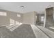 Bright living room with plush carpet and an open layout leading to the entrance and staircase at 6770 W Buck Stone Dr, McCordsville, IN 46055