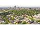 Scenic aerial view of residential neighborhood showcasing lush trees, diverse housing, and the city skyline at 711 E 16Th St, Indianapolis, IN 46202