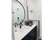 Modern bathroom with white countertop, vessel sink, round mirror, and a glass-enclosed shower at 711 E 16Th St, Indianapolis, IN 46202