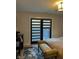 Bedroom featuring black-out blinds, area rug, and bench at 711 E 16Th St, Indianapolis, IN 46202