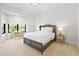 This bedroom features a decorative bed frame, neutral carpet, and a bright window with a desk at 711 E 16Th St, Indianapolis, IN 46202