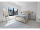 Bright bedroom featuring a large window, a decorative wood frame bed and neutral colored carpet at 711 E 16Th St, Indianapolis, IN 46202